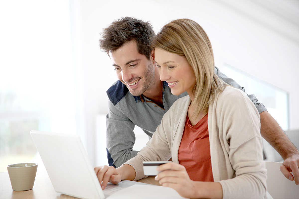 Man and Woman using Online payment processing on laptop